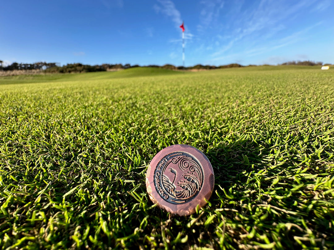 Forged iron golf ball marker on a traditional fescue green