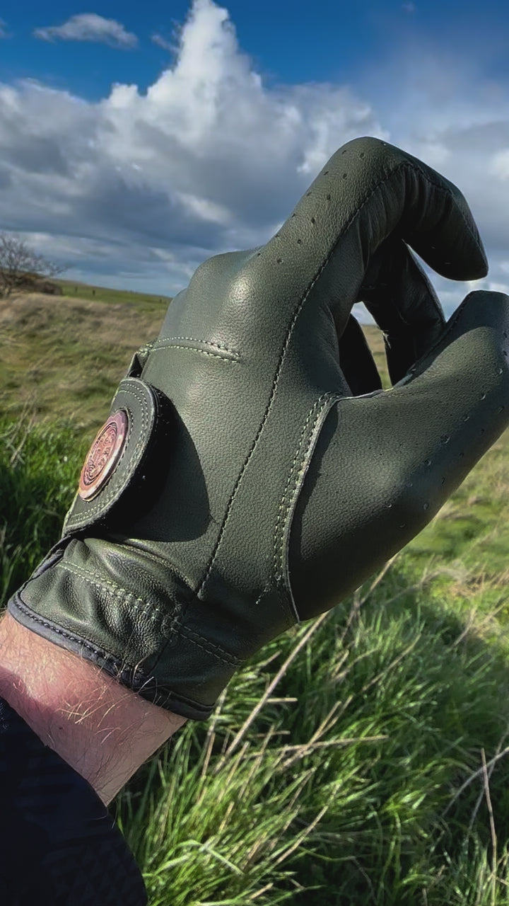 Detail video of the beautiful cabretta leather & logo on a premium golf glove by Links Collective in the sunshine and wind on a scottish golf course.