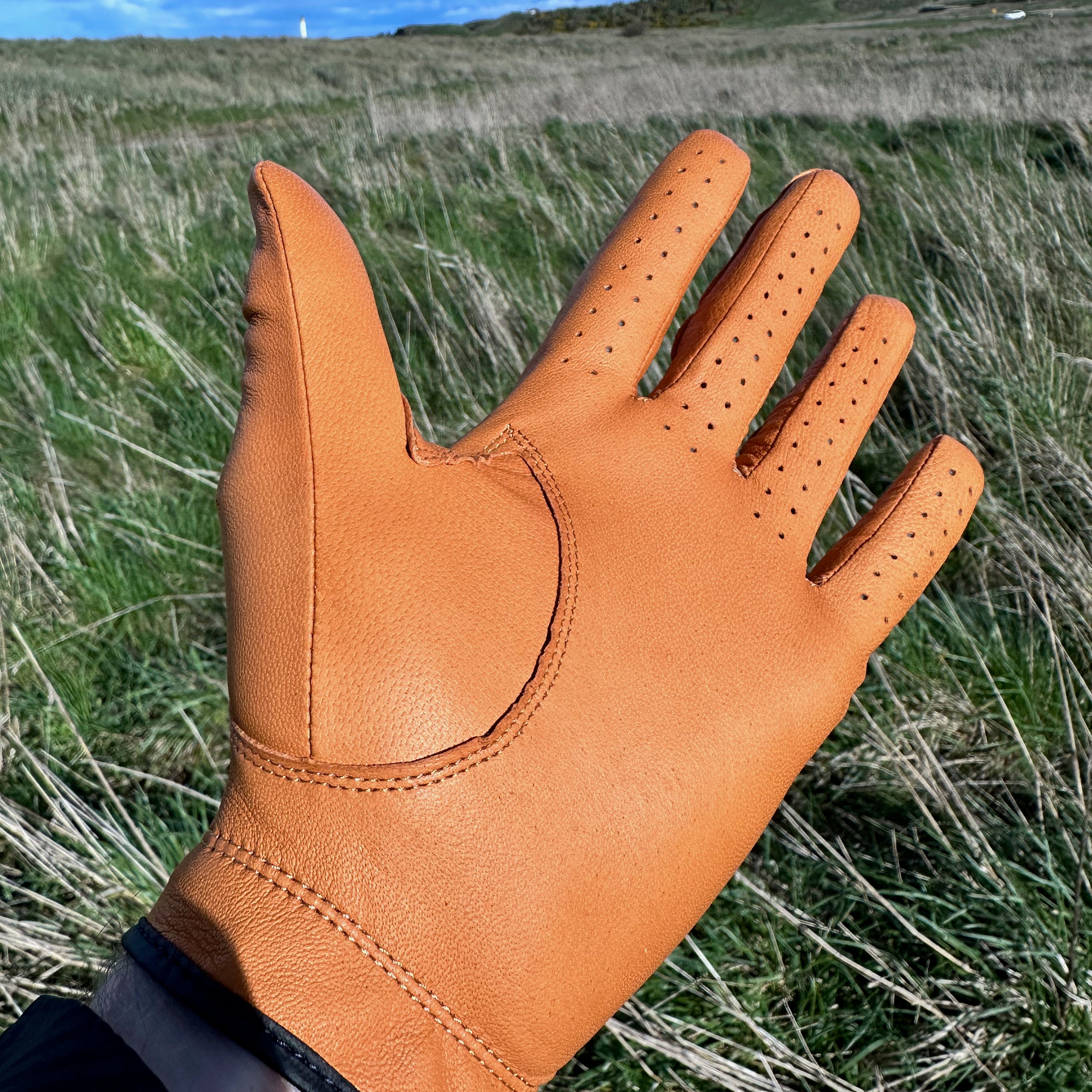 Golfer's point of view while wearing The Links Glove, looking at the dunes with the fairway ahead.