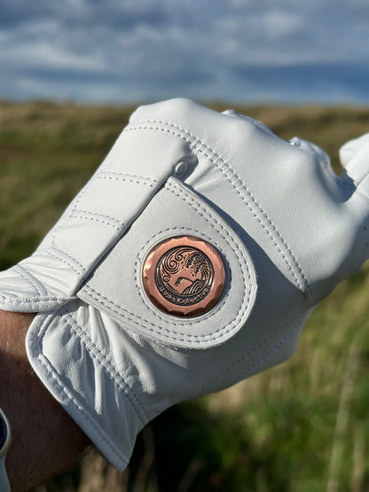 Close-up shot of the high-quality Cabretta leather on a Links Collective white golf glove, highlighting the durability on a sunny green golf course